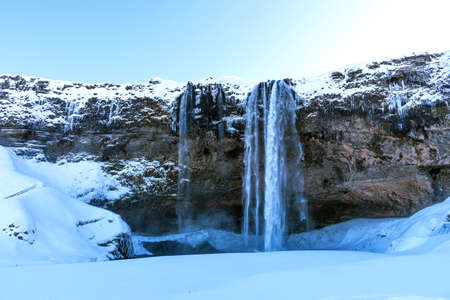 Picturesque winter landscape view of frozen beautiful waterfall Seljalandsfoss in Iceland. Aereal winter landscape view of waterfall Seljalandsfoss in Iceland.の写真素材