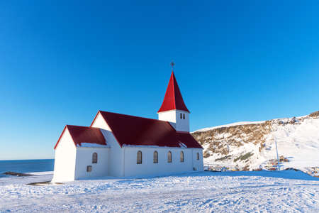 Picturesque aerial view of Vik I Myrdal church on the top of hill in Iceland.の写真素材