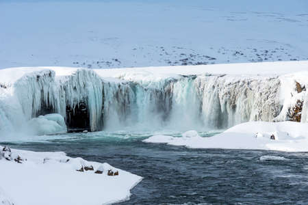 Scenic winter view of Godafoss waterfall in Iceland. Picturesque winter landscape with frozen waterfall in Iceland.の写真素材