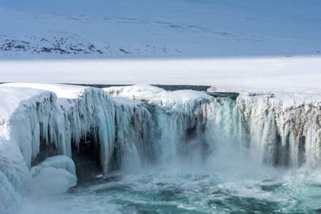 Scenic winter view of Godafoss waterfall in Iceland. Picturesque winter landscape with frozen waterfall in Iceland.の写真素材