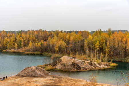 Aerial Autumn view with yellow trees, picturesque hills and blue lakes in Konduki, Tula region, Russia. Turquoise quarry in Romantsevo. Ushakovskiye quarries.の写真素材