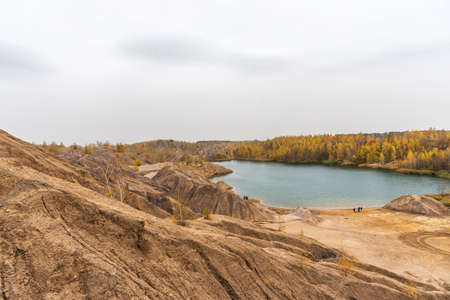 Aerial Autumn view with yellow trees, picturesque hills and blue lakes in Konduki, Tula region, Russia. Turquoise quarry in Romantsevo. Ushakovskiye quarries.の写真素材
