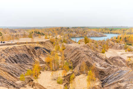 Aerial Autumn view with yellow trees, picturesque hills and blue lakes in Konduki, Tula region, Russia. Turquoise quarry in Romantsevo. Ushakovskiye quarries.の写真素材