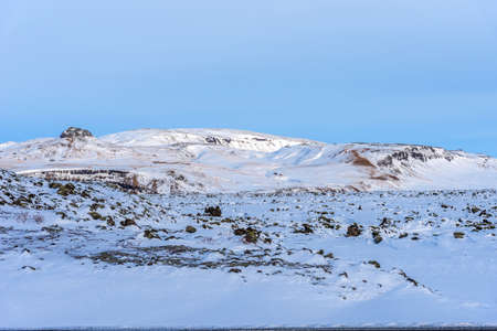 Beautiful winter landscape with mountains covered snow, cold frosty weather and white field in Iceland.の写真素材