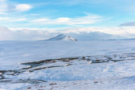 Beautiful winter landscape with mountains covered snow, cold frosty weather and white field in Iceland.の写真素材