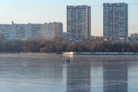 Moscow, Russia - December 4, 2020: People skate on the frozen Moscow Canal in Russia. People on the frozen river. Winter landscape of the Moscow canal with people. The frozen canal Moscow.のeditorial素材