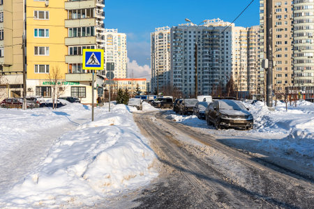 Moscow, Russia - February 18, 2021: Snow-covered cars after heavy snowfall in Moscow. A road in a residential area after a heavy snowfall. The car is covered with snow and is parked in the courtyard of a residential area.のeditorial素材