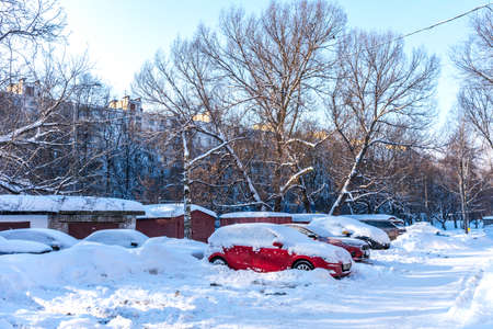 Moscow, Russia - February 18, 2021: Snow covered car after heavy snowfall in Moscow. The car is covered with snow and is parked in the courtyard of a residential area.のeditorial素材