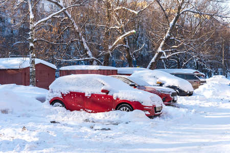 Moscow, Russia - February 18, 2021: Snow covered car after heavy snowfall in Moscow. The car is covered with snow and is parked in the courtyard of a residential area.のeditorial素材