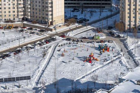 Moscow, Russia - February 16, 2021: Children playground under the snow in a residential area of Moscow. Panoramic view of houses, courtyards and a playground in the Southeast District of Moscow.のeditorial素材