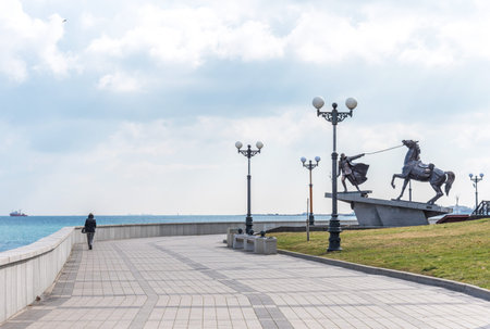 Novorossiysk, Russia - March 3, 2021: Panoramic view of the pedestrian embankment in Novorossiysk in early spring, Russia. Monument Exodus on the embankment of Novorossiyskのeditorial素材
