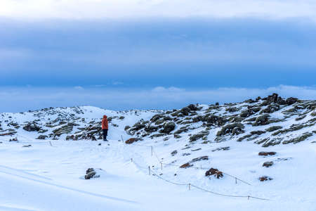 Typical Icelandic winter landscape with picturesque blue sky. Beautiful winter landscape with mountains covered snow, cold frosty weather and white field in Iceland.の写真素材
