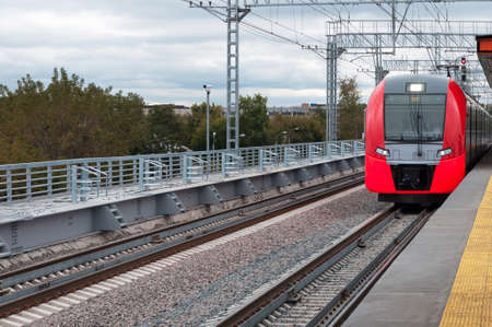 Moscow, Russia - September 18, 2016: Moscow Central Circle or MCC. High-speed Lastochka train arrives at the stationのeditorial素材