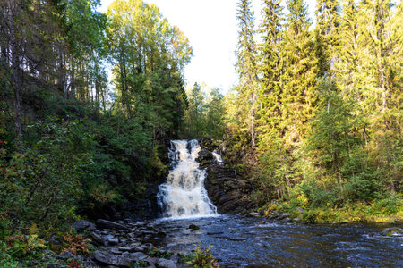 Picturesque autumn view of White Mosty waterfall in Karelia. Amazing landscape with forest waterfall in North of Karelia.の写真素材