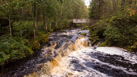 A beautiful view of Jukankoski the highest waterfalls in the Northern Ladoga area. Picturesque autumn view of White Bridges Waterfall in Kareliaの写真素材