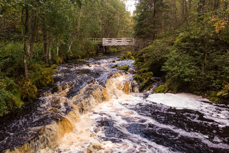 A beautiful view of Jukankoski the highest waterfalls in the Northern Ladoga area. Picturesque autumn view of White Bridges Waterfall in Kareliaの写真素材