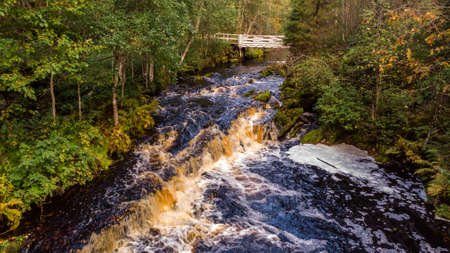A beautiful view of Jukankoski the highest waterfalls in the Northern Ladoga area. Picturesque autumn view of White Bridges Waterfall in Kareliaの写真素材