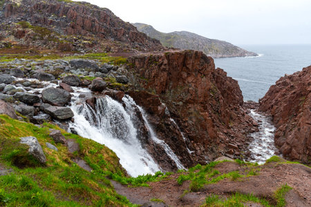 Summer view of waterfall near Battery Lake in Teriberka on the Kola Peninsula, Russia.の写真素材