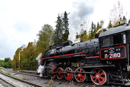 Ruskeala, Russia - September 13, 2021: Steam-powered tourist Retro train Ruskeala Express in Ruskeala Park railway station in Karelia, Russia. popular tourist attraction.のeditorial素材
