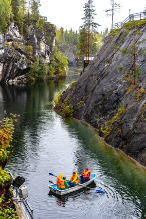 Ruskeala, Russia - September 13, 2021: View of Grand Marble Canyon of Ruskeala mountain park in Karelia. popular tourist attraction. People are boating on the lake.のeditorial素材