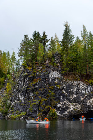 Ruskeala, Russia - September 13, 2021: View of Grand Marble Canyon of Ruskeala mountain park in Karelia. popular tourist attraction. People are boating on the lake.のeditorial素材