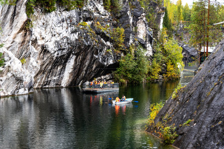 Ruskeala, Russia - September 13, 2021: View of Grand Marble Canyon of Ruskeala mountain park in Karelia. popular tourist attraction. People are boating on the lake.のeditorial素材