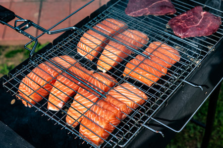 Steak and salmon on barbecue grill in summer. Steak and salmon on the grill.の写真素材