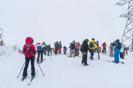 Elbrus, Russian Federation - January 20, 2024: People snowboard and ski during heavy snowfall on Elbrus in winter. Elbrus in heavy snowfall.のeditorial素材