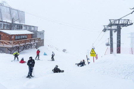 Elbrus, Russian Federation - January 20, 2024: People snowboard and ski during heavy snowfall on Elbrus in winter. Elbrus in heavy snowfall. Station Krugozorのeditorial素材
