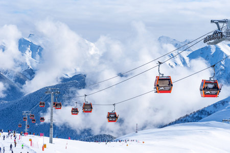 Arkhyz, Russian Federation - January 23, 2024: Tourists ski and snowboard at the Arkhyz resort. Ski...