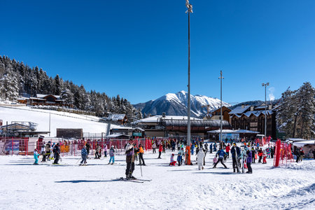 Arkhyz, Russian Federation - January 24, 2024: Tourists ski and snowboard at the Arkhyz resort. Ski lifts in the Arkhyz resort on a sunny day in winter.のeditorial素材
