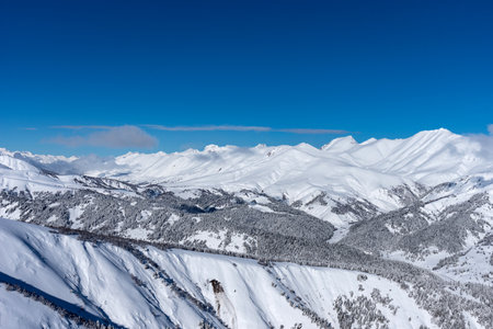 Picturesque winter landscape of the Arkhyz ski resort with mountains, snow, forest on sunny day.の写真素材