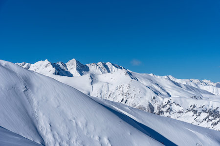 Picturesque winter landscape of the Arkhyz with mountains, snow, forest on sunny day. Caucasus Mountains, Russia.の写真素材