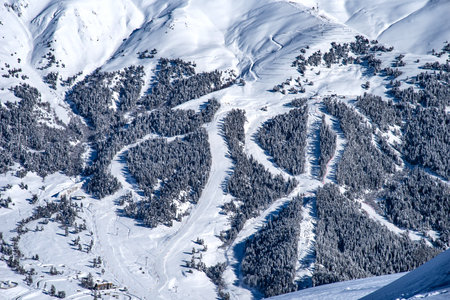 Picturesque winter landscape of the Arkhyz ski resort with mountains, snow, forest on sunny day. Caucasus Mountains, Russia.の写真素材