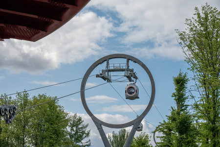 A close-up view of the new and modern cableway at VDNKh in Moscow. Dramatic sky.