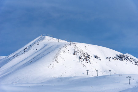 Aerial view of snow-covered ski slopes in Gudauri. Winter sports and snowy peaks at Gudauri resort on sunny winter day.の写真素材