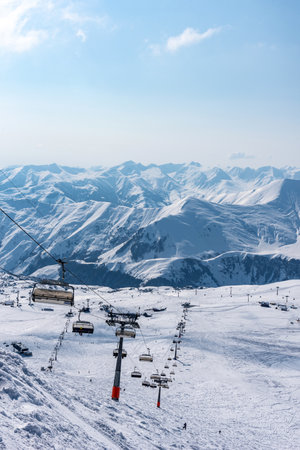 Aerial view of snow-covered ski slopes in Gudauri. Winter sports and snowy peaks at Gudauri resort on sunny winter day.の写真素材