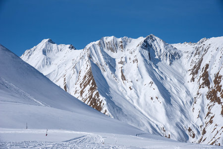 Winter view of the Caucasus Range in Gudauri, Georgia. Aerial view of snow-covered ski slopes at the...
