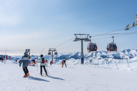 Gudauri, Georgia - February 10, 2025: Aerial view of snow-covered ski slopes in Gudauri. Winter sports and snowy peaks at Gudauri resort on sunny winter day.