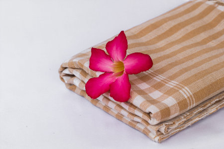 The Red flowers lay on brown clothの写真素材