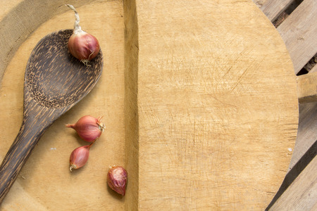 Chilies, shallots, garlic, spices, utensils, surfaces, flooring.の写真素材