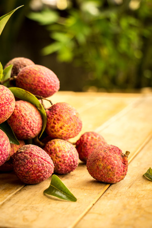 Lychee, red, floor boards, flooring, background, texture, fruit.の写真素材