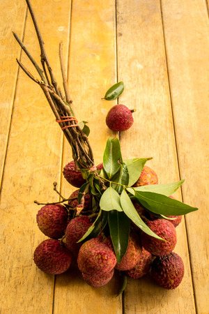 Lychee, red, floor boards, flooring, background, texture, fruit.の写真素材