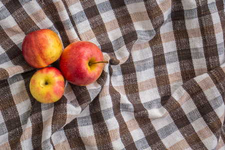 Red apple on wooden background, shot from aboveの写真素材