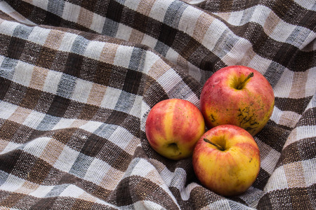 Red apple on wooden background, shot from aboveの写真素材