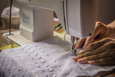 seamstress while working with the sewing machine