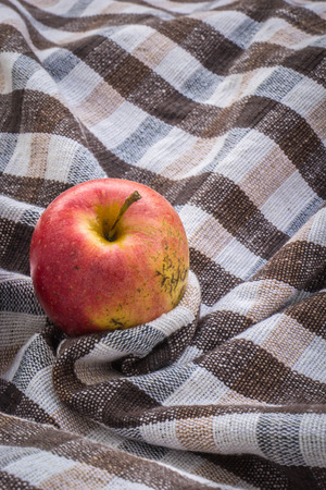 Red apple on wooden background, shot from aboveの写真素材