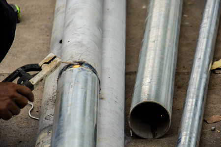 working with grinder, close up on tool, hands and sparks, real situation pictureの写真素材