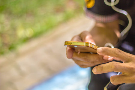 Close up of a man using mobile smart phoneの写真素材
