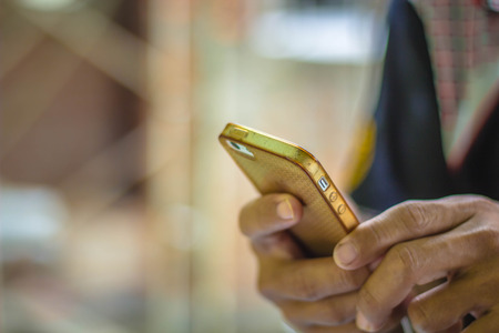 Close up of a man using mobile smart phoneの写真素材